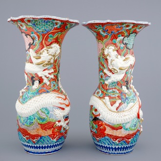 A tall pair of Japanese relief-moulded dragon vases, 19th C.