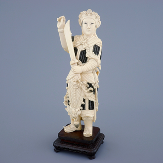 A Chinese carved ivory figure of a female warrior on a wooden base, late 19th C.