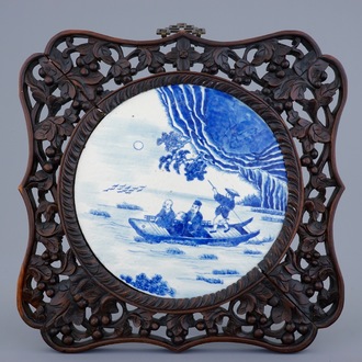 A Chinese blue and white plaque in sculpted frame, 19th C.