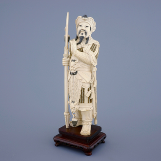 A Chinese carved ivory figure of a warrior on a wooden base, late 19th C.