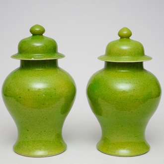 A pair of Chinese monochrome lime green vases and covers, 19/20th C.