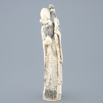 A tall Chinese carved ivory figure of Shou Lao, late 19th C.