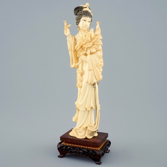 A Chinese carved ivory figure of a lady on wooden base, early 20th C.