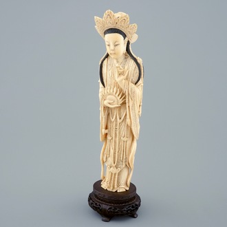 A Chinese carved ivory figure of Guanyin on wooden base, early 20th C.