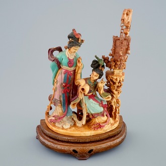 A Chinese polychrome carved ivory group on wooden base, 19th C.