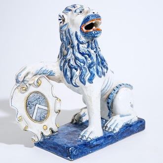 A large Dutch Delft figure of a lion with a coat of arms, 19th C.