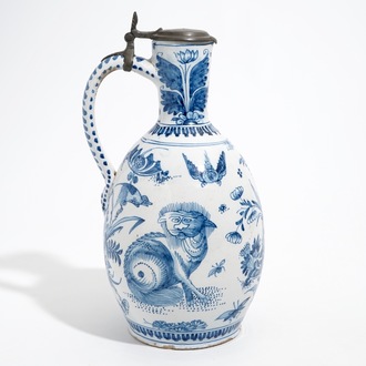 A large Dutch Delft blue and white jug with a tiger and a lion, 17th C.