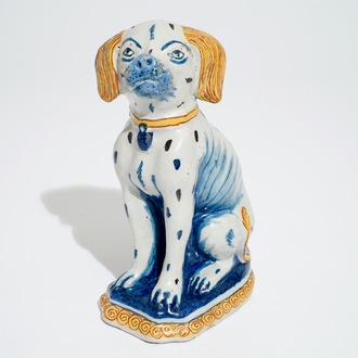 A polychrome Dutch Delft model of a seated dog, 18th C.