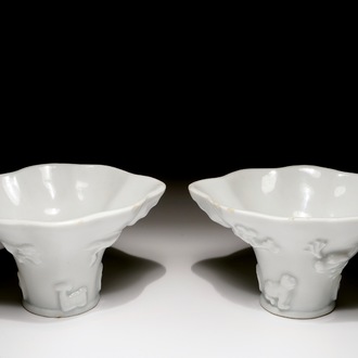 A pair of blanc de Chine relief decorated libation cups, Kangxi