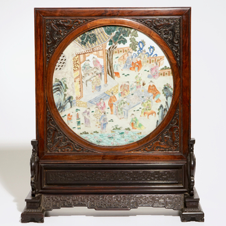 A Chinese zitan and huanghuali wood table screen with famille rose inset plaque, early 19th C.