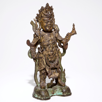 A tall Chinese gilt bronze figure with traces of polychromy, Ming