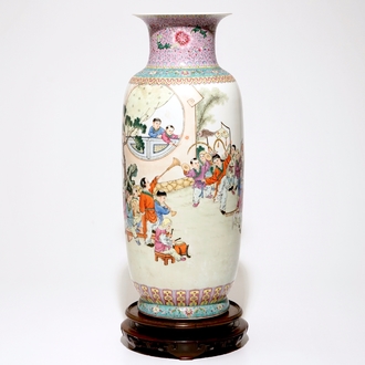 A large Chinese famille rose vase with playing boys, on a wooden stand, 20th C.