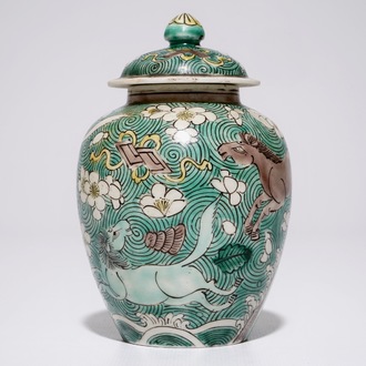 A Chinese verte biscuit covered jar with horses, Kangxi