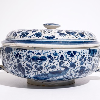 A Dutch Delft blue and white spiced wine bowl and cover with peacocks, early 18th C.