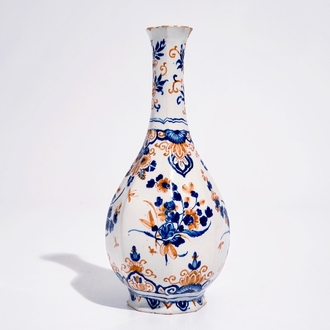 A Dutch Delft bottle vase with a floral chinoiserie design in red and blue, 1st quarter 18th C.