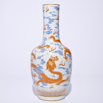 A Chinese iron red and overglaze blue vase with dragons among clouds, 19/20th C.