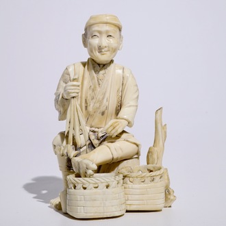 A Japanese ivory okimono of a vegetable seller, Meiji, early 20th C.