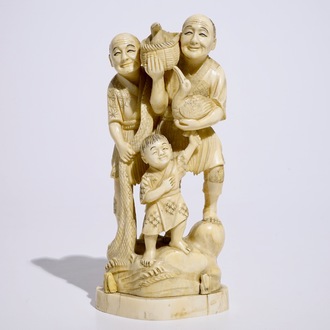 A Japanese ivory okimono of bird catchers, Meiji, early 20th C., signed