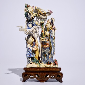 A polychrome Chinese ivory group of an immortal with children, early 20th C.