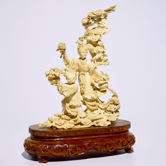 A Chinese carved ivory group of Lan Cai He with a servant, early 20th C.