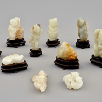 Ten various small jade carvings on wooden bases, 19/20th C.