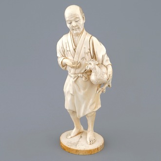 A Japanese ivory okimono of a chicken farmer, Meiji, 19th C., signed