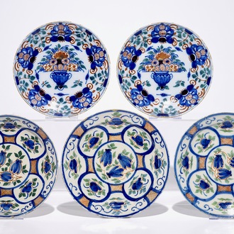 A pair and a set of three Dutch Delft polychrome plates, 18th C.