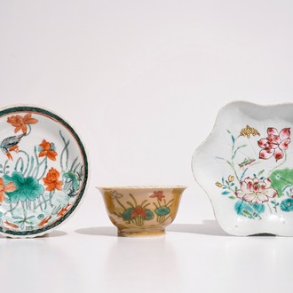 A Chinese famille verte café au lait ground cup and saucer, Kangxi, together with a famille rose teapot stand, Yongzheng