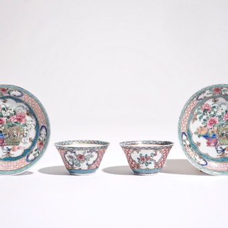 A pair of Chinese famille rose cups and saucers with a cat near a flower basket, Yongzheng