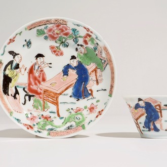 A Chinese famille rose cup and saucer with a tea-drinking scene, Yongzheng