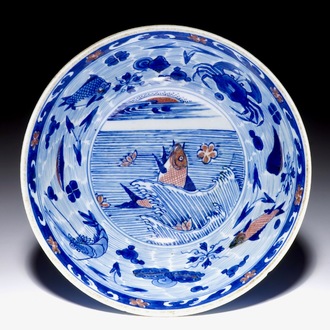 A rare Chinese blue and underglaze red bowl with carps and marine animals, Kangxi mark and of the period