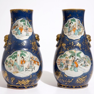 A pair of Chinese famille verte on powder blue and gilt ground vases, 19th C.