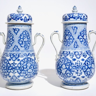 A pair of Chinese blue and white covered urns, Kangxi