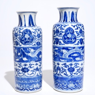 A near pair of Chinese blue and white rouleau vases with dragon panels, Kangxi