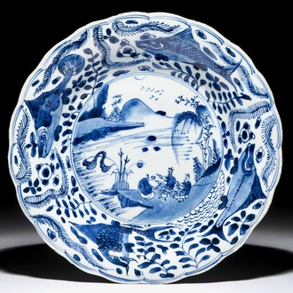 A Chinese blue and white dish with carps on the rim, Kangxi