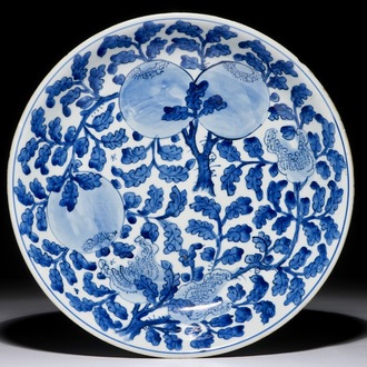 A Chinese blue and white dish with sanduo fruits among foliage, Kangxi