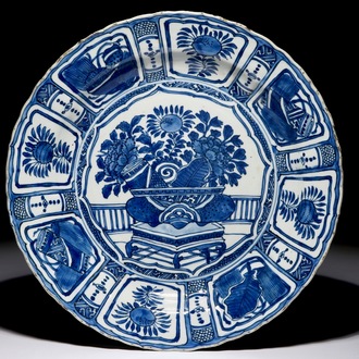 A Chinese blue and white kraak porcelain charger with a flower vase, Wanli