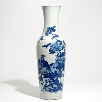 A tall Chinese blue and white vase with pheasants among flower blossoms, 19th C.