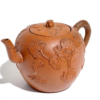 A Chinese Yixing stoneware teapot and cover with applied decoration, Kangxi