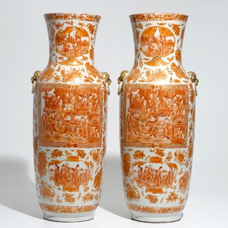 A pair of tall Chinese iron red and gilt vases, 19th C.