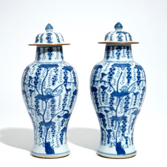 A pair of Chinese blue and white vases and covers with grapes, Kangxi