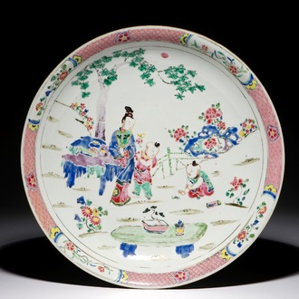 A Chinese famille rose dish with figures in a garden, Yongzheng