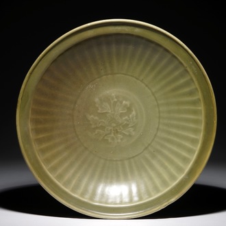 A Chinese Longquan celadon dish with floral underglaze design, Ming