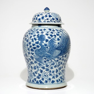 A tall Chinese blue and white baluster jar and cover with a phoenix, 19th C.