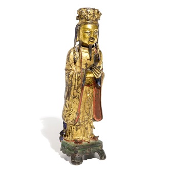 Een Chinese deels vergulde en polychrome bronzen figuur van Wenchang Dijun, Ming