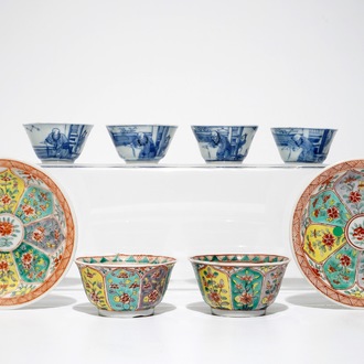 A pair of Chinese famille verte cups and saucers and four blue and white cups, Kangxi