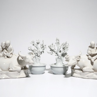 A pair of Chinese Dehua blanc de Chine prunus trees, Kangxi, and a pair of water buffalos with children, 20th C.