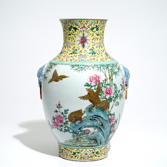 A Chinese famille rose hu vase with birds among flowers on rockwork, Qianlong mark, 19/20th C.