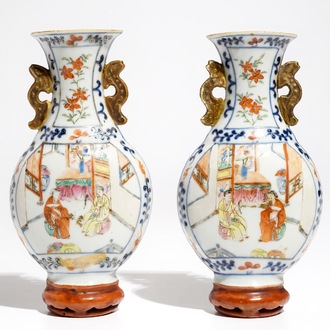 A pair of Chinese famille rose wall vases with figural design, 19th C.