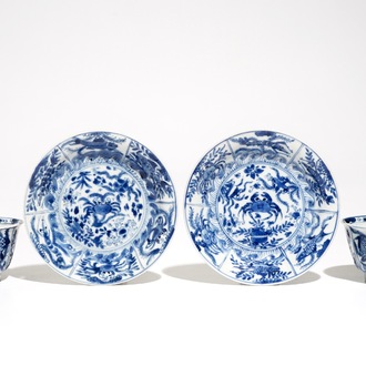 A pair of Chinese bleu and white cups and saucers with crabs and fish, Kangxi